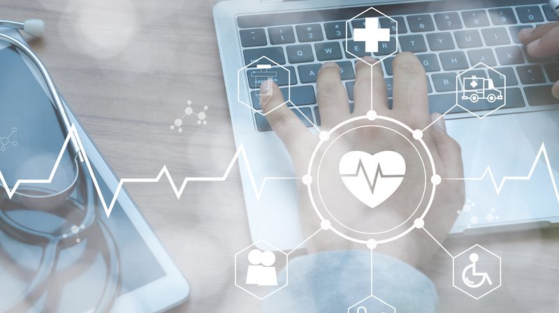Stethoscope lies on tablet and white icon medical with hand doctor using laptop to securely exchange healthcare data. Healthcare business technology network concept.